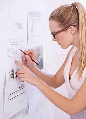 Buy stock photo Shot of an attractive young architect working in her studio