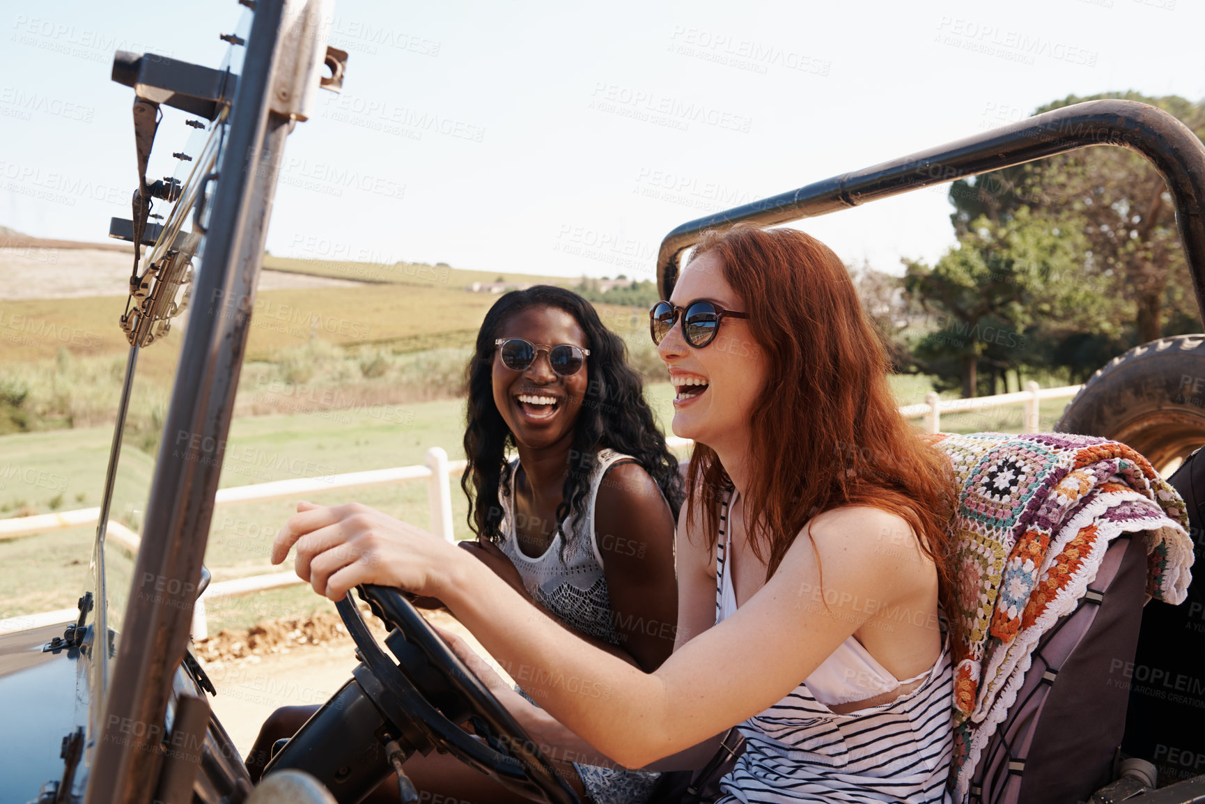 Buy stock photo Shot of two young women laughing in the car
