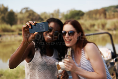 Buy stock photo Women, selfie and vacation for road trip by river, memory and travel adventure for social media in nature. Ladies, cellphone and profile picture by van on holiday, care and bonding together on safari