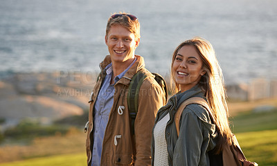 Buy stock photo Love, portrait and happy couple on hike with ocean, sunset for tropical holiday adventure, relax and bonding together. Smile, man and woman on romantic date with beach, nature and grass on vacation