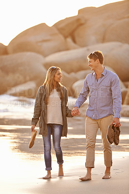 Buy stock photo Love, holding hands and couple on walk with ocean, sunset and tropical holiday adventure, relax and bonding together. Rocks, man and woman on romantic date with beach, nature and travel on vacation