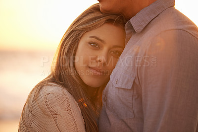 Buy stock photo Couple, portrait and hug for love at beach, ocean waves and peace for romance in relationship. Happy woman, care and security in marriage, embrace and travel on vacation or holiday for outdoor date