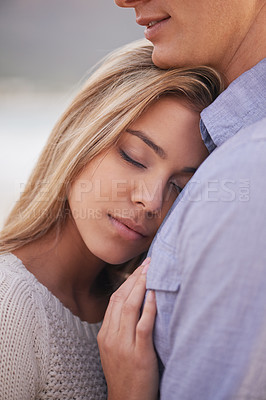 Buy stock photo Couple, relax and hug for love by water, ocean waves and peace for romance in relationship. People, closeup and commitment in marriage, embrace and travel on vacation or holiday for outdoor date