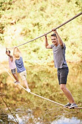 Buy stock photo Nature, camp and boy with balance on rope for adventure, summer holiday and fun challenge in Canada. Teenager, hanging and portrait with smile for vacation, enjoyment and exercise in forest by river
