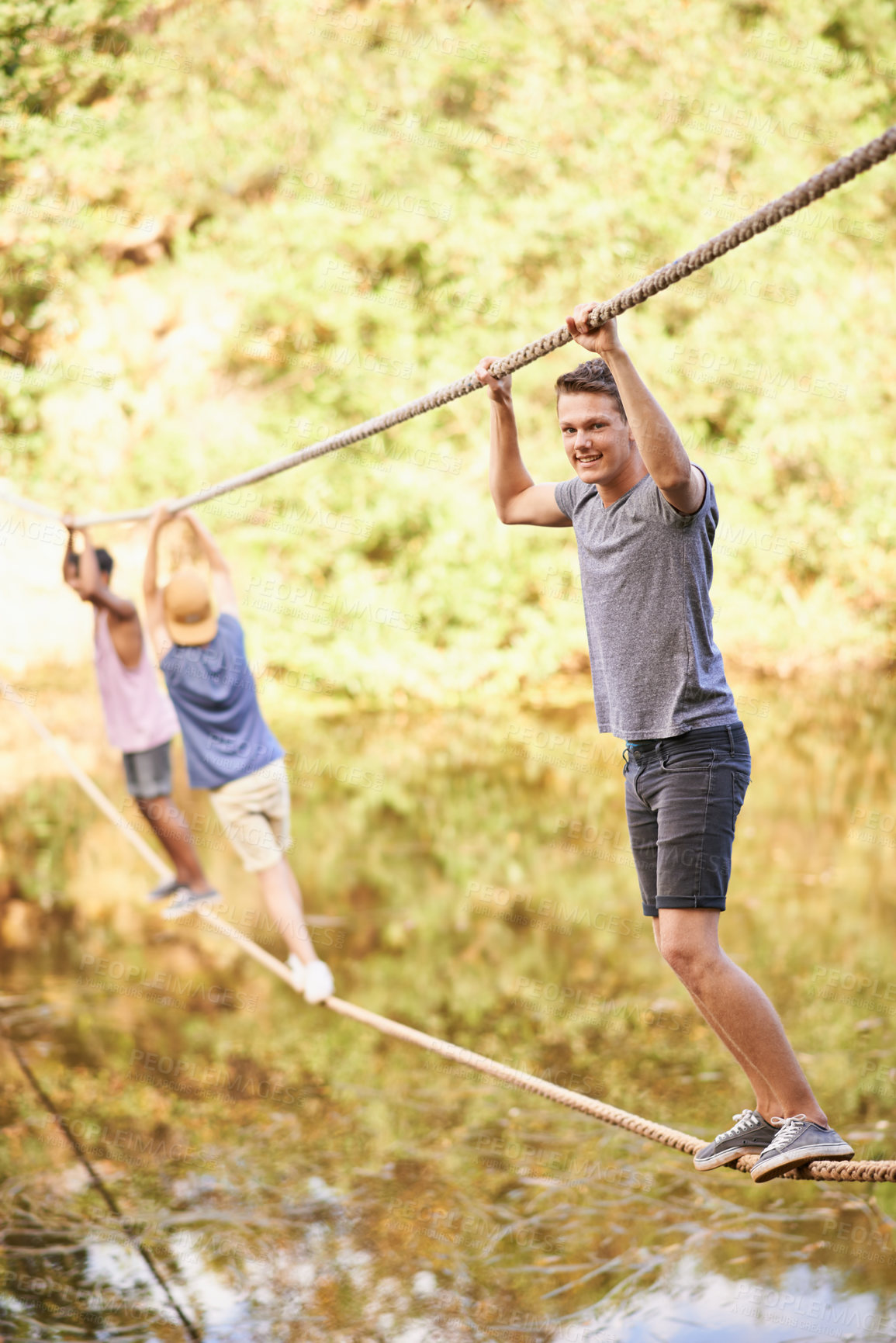 Buy stock photo Nature, camp and boy with balance on rope for adventure, summer holiday and fun challenge in Canada. Teenager, hanging and portrait with smile for vacation, enjoyment and exercise in forest by river