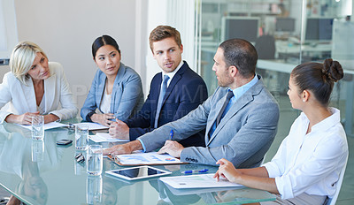 Buy stock photo Cropped shot of a group of business colleagues meeting in the boardroom