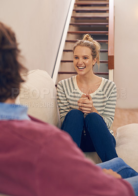 Buy stock photo Love, couple and bonding on a sofa with chat, conversation or sharing gossip in their home. Trust, support and woman person in a living room excited about story, communication or chilling in a house