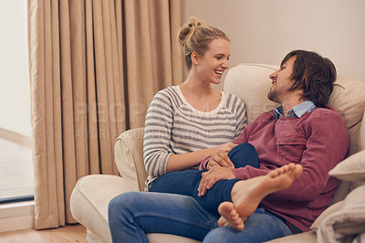 Buy stock photo Love, relax and couple on a sofa for bonding, chilling or flirting fun on weekend at home together. Happy, comfort and people in a living room with trust, support and care, security or conversation