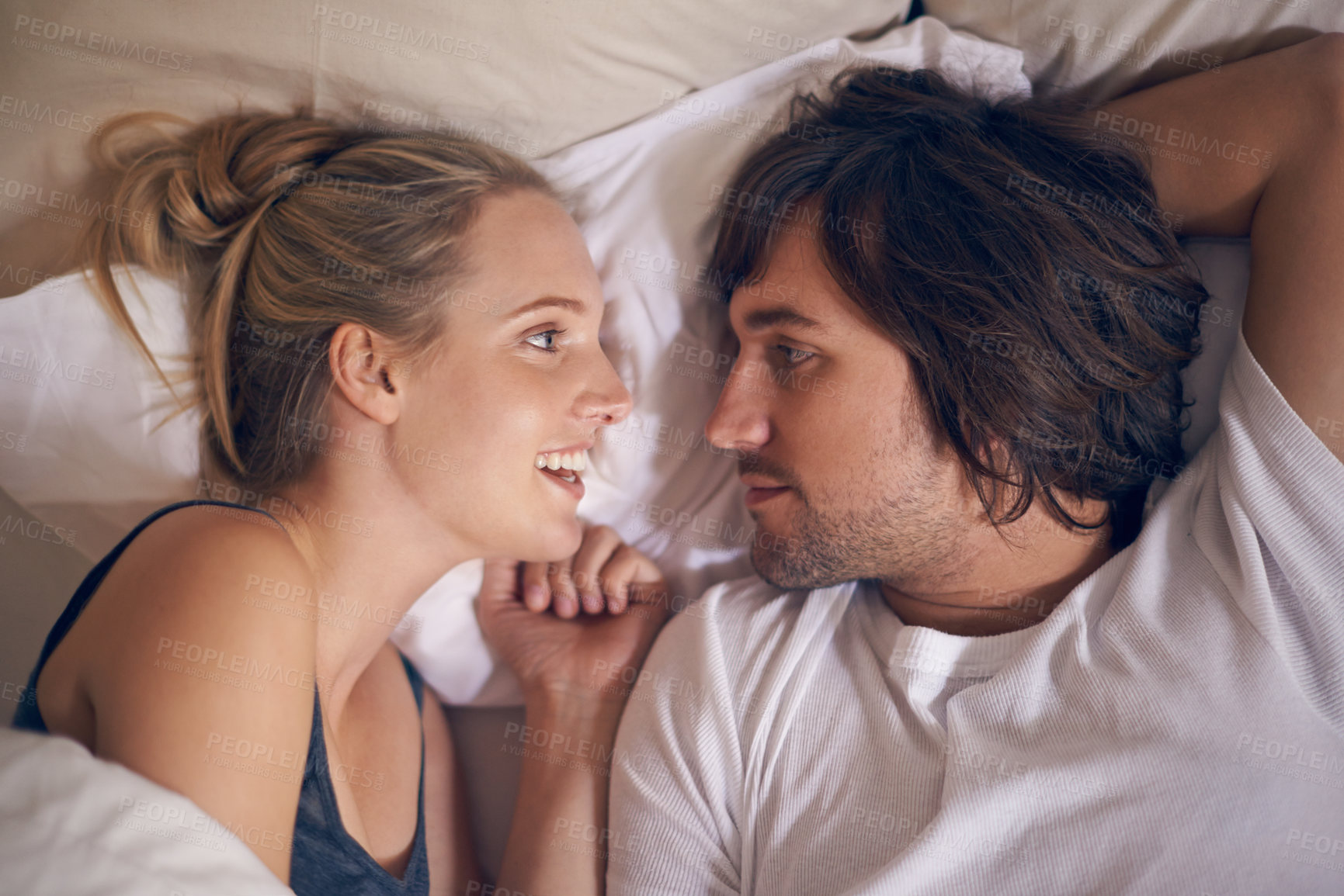 Buy stock photo Love, relax and couple in a bed talking, bonding and resting in their home from above. Wake up, conversation and people in a bedroom with morning speaking, chat or chilling in a house on weekend