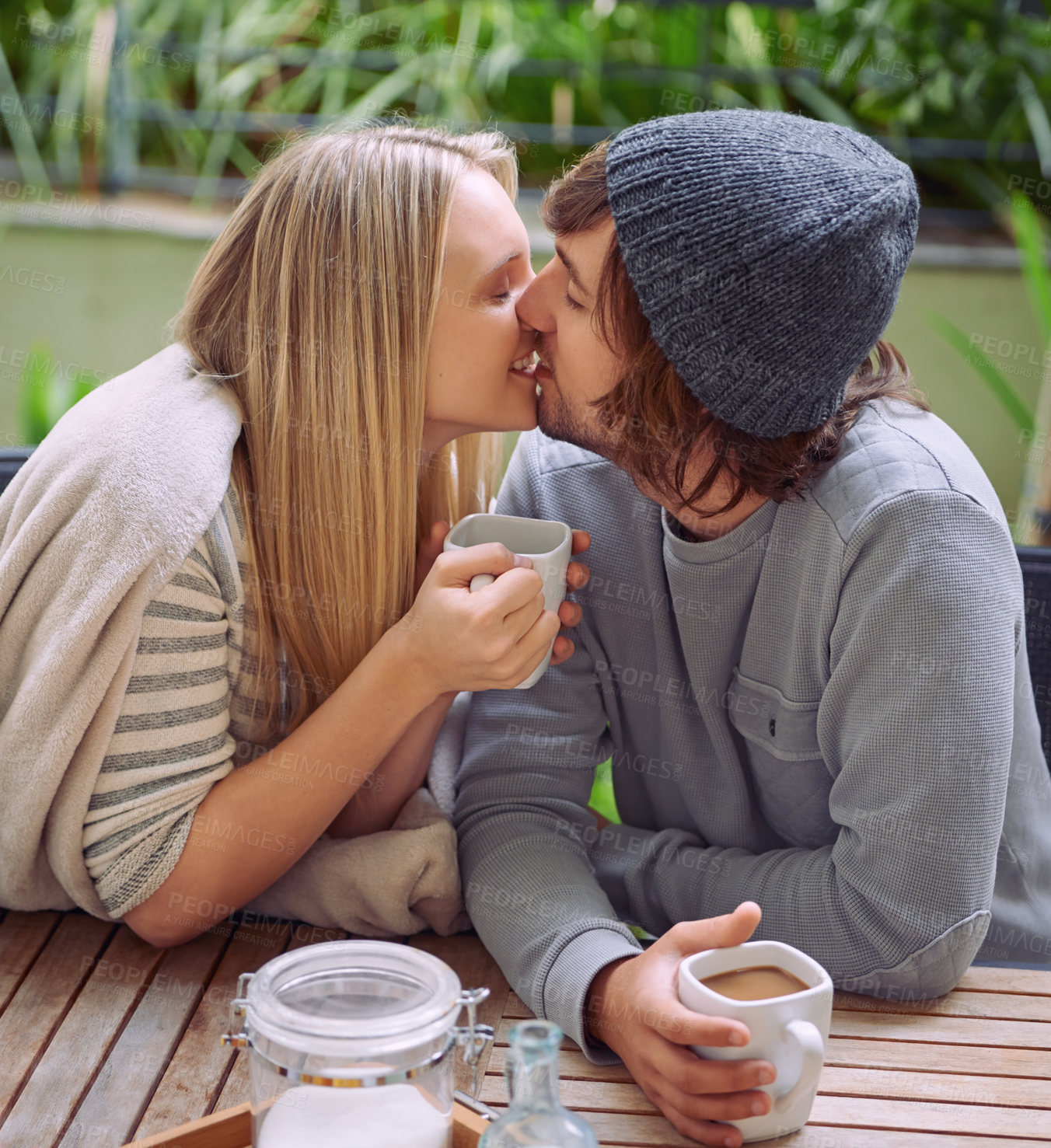 Buy stock photo Kiss, garden and couple with coffee in morning with drink, caffeine beverage and cappuccino outdoors. Happy, love and man and woman with mug in backyard for breakfast, bonding and wellness together