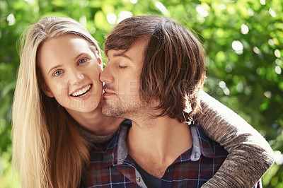 Buy stock photo Portrait of a smiling young couple hugging each other  in the park