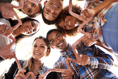 Buy stock photo Portrait, finger star and friends in circle with diversity, unity and collaboration with low angle. Happy, smile and group of people in huddle together with hand gesture for solidarity and community.