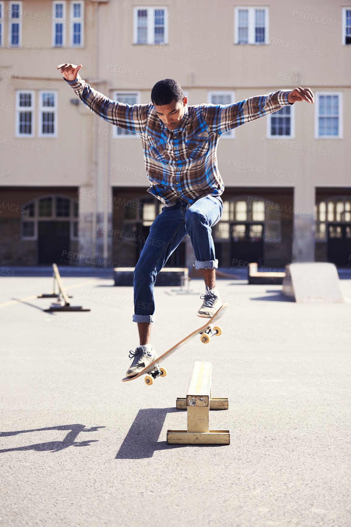 Buy stock photo Man, skateboard and jumping at urban skatepark, sports and energy with skill, stunt and recreation activity outdoor. Skateboarder, confidence and trick, training and workout for balance and exercise