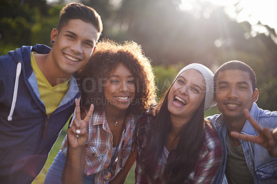 Buy stock photo Portrait, smile and diversity friends in nature, outdoors or garden with happy expression. Social, joy and peace sign hand gesture from group of student, summer and sunset with lens flare outside 