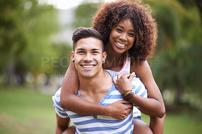 Buy stock photo Cropped portrait of a young man giving his girlfriend a piggyback ride at the park