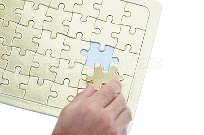 Buy stock photo Person, hands and puzzle with piece for problem solving, solution or building on a white studio background. Closeup of creative with jigsaw board for thinking, development or matching on mockup space