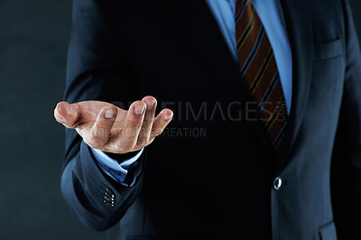 Buy stock photo Businessman, empty and offer helping hand for invitation, giving assistance or welcome in studio with black background. Palm, collaboration and male person and for agreement, support or acceptance