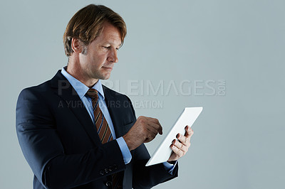 Buy stock photo Cropped shot of a businessman using a digital  tablet
