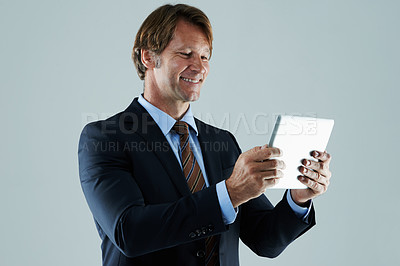 Buy stock photo Cropped shot of a businessman using a digital  tablet