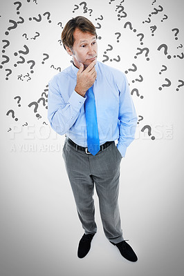Buy stock photo Businessman, thinking and idea with question marks for choice or decision on a gray studio background. Thoughtful man or employee in wonder, thought or contemplating selection or answer on mockup