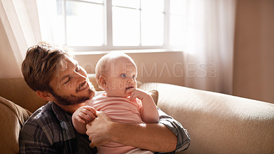 Buy stock photo Smile, father and hug baby on sofa in home living room, playing or bonding together. Happiness, care and dad embrace infant, newborn or child on couch in lounge, having fun and enjoying quality time.