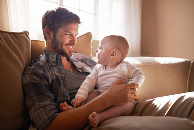 Buy stock photo Cropped shot of an affectionate father bonding with his baby girl at home