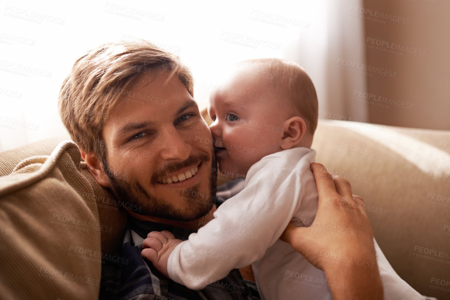 Buy stock photo Smile, father and face with baby on sofa in home living room, playing or bonding together. Kiss, care and dad with infant, newborn or child on couch in lounge, having fun or enjoying quality time