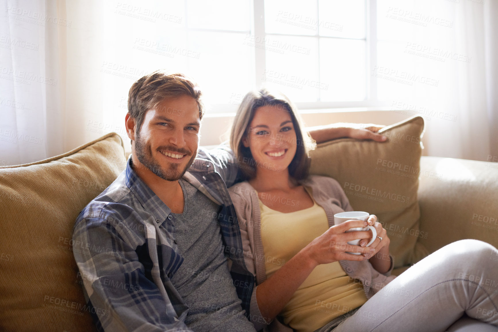 Buy stock photo Portrait, coffee and couple relax or smile on a couch together or bonding in the living room and with tea. Man, woman and love or affection with hot beverages or on a break and happy partners at home