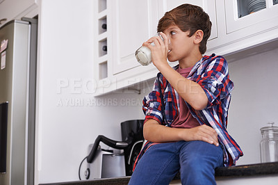 Buy stock photo A young boy drinking a glass of milk