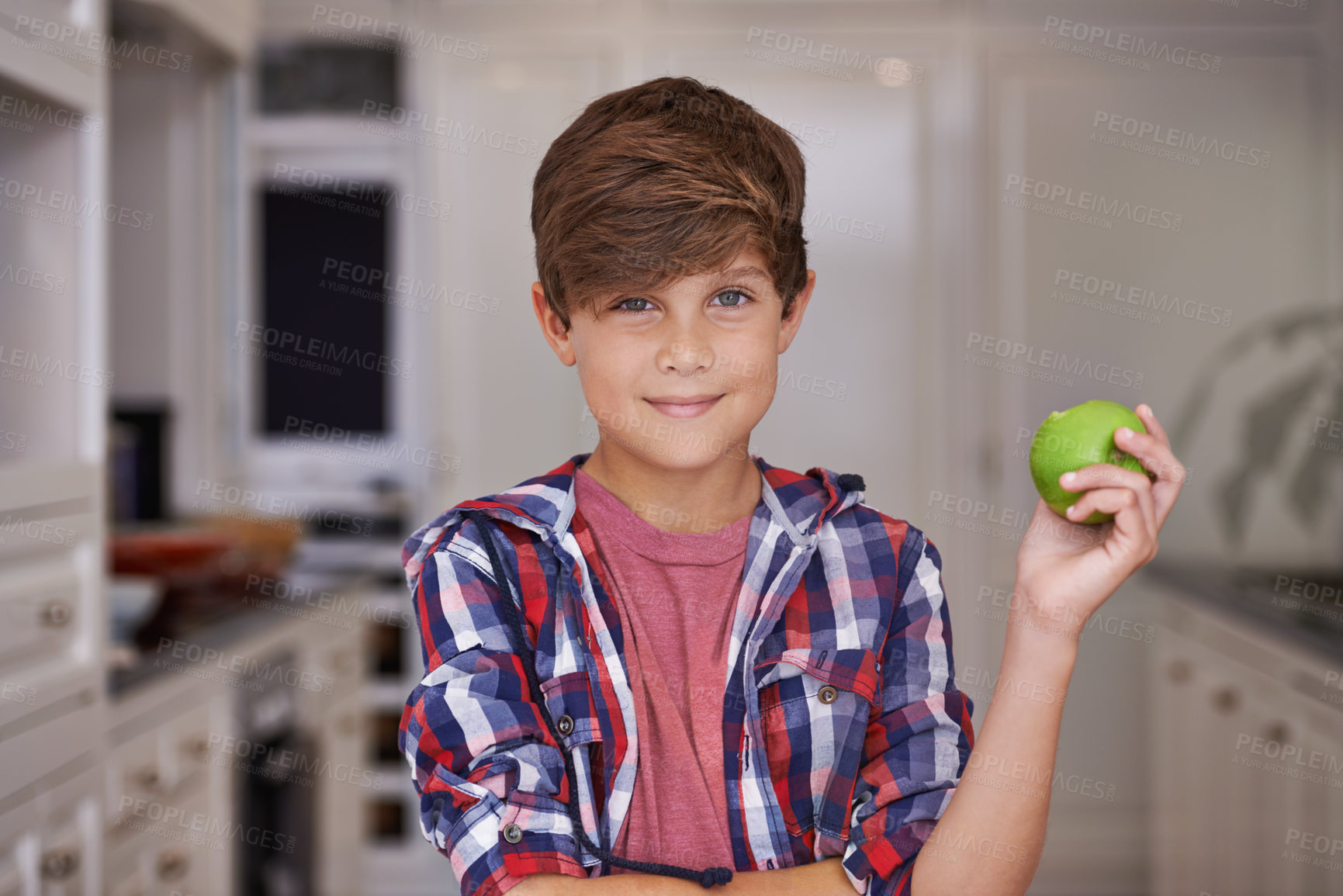 Buy stock photo Boy, smile and portrait in kitchen with apple for nutrition, breakfast and health in house for snack. Child or kid in home with fruit for vitamin, nutrient and fibre for meal, delicious and raw  