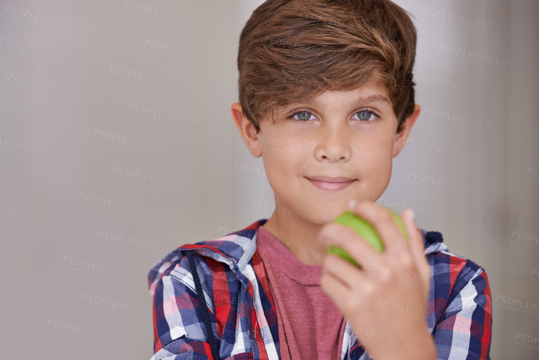 Buy stock photo Portrait, apple and boy child in home, eating green fruit as diet, health or nutrition for development. Face, food and natural with confident young teen kid holding organic produce in apartment