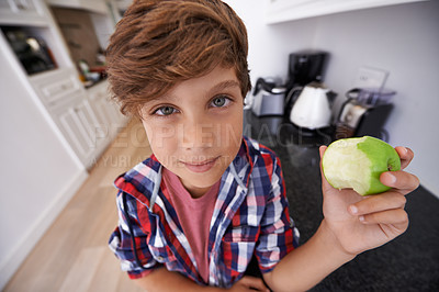 Buy stock photo Portrait, apple and children with boy in kitchen of home for health, organic diet or nutrition. Face, fruit and confident young teen kid eating green food in apartment for growth or development