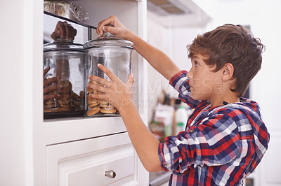 Buy stock photo Cookies, kitchen and snack for boy in house for steal, sneaky or sugar in pantry or cupboard for meal. Young person or kid with hand in jar for biscuit, sweet or naughty for wrong or childhood 