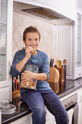 Buy stock photo Portrait, smile and cookie jar with boy child in kitchen of home, eating biscuits on counter in morning. Breakfast, food and relax with happy young kid in apartment for hunger, snack or treats