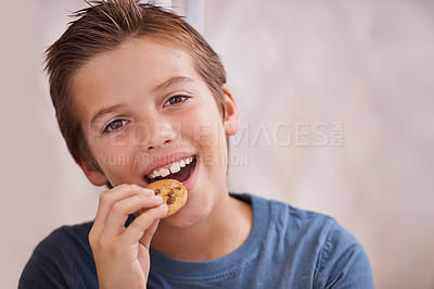 Buy stock photo Portrait, smile and boy eating cookie in kitchen of home for hunger, sweet snack or treats. Face, food or biscuit with happy young teen kid biting baked goods alone in apartment for satisfaction