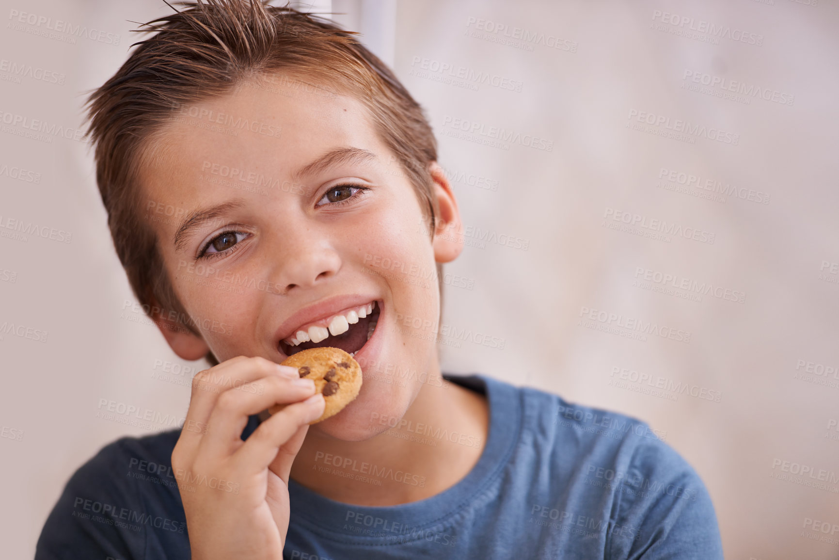 Buy stock photo Portrait, smile and boy eating cookie in kitchen of home for hunger, sweet snack or treats. Face, food or biscuit with happy young teen kid biting baked goods alone in apartment for satisfaction