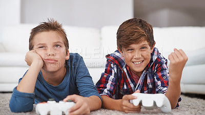 Buy stock photo Happy, children and winning a video game in home with friends in online competition for esports challenge. Excited, kid and celebration of gaming victory in contest with sad boy on floor of lounge 