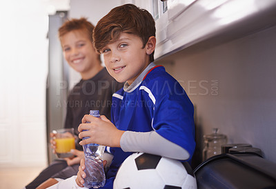 Buy stock photo Children, portrait and soccer ball as friends in home with drink for sports training in kitchen for exercise, workout or juice. Male people, athlete and face in apartment with water, cardio or kit