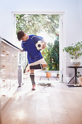 Buy stock photo Shot of a young boy holding a soccer ball