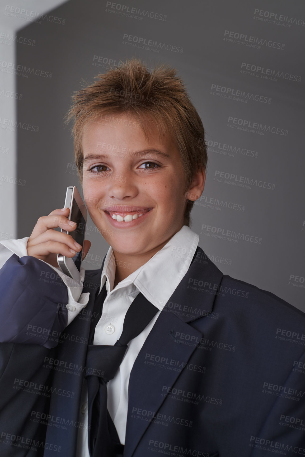 Buy stock photo Portrait, child and pretend suit on boy, smartphone or business call for dream job or dress up on kid. Smile, happy in clothes on career day for school, talk on communication technology with costume
