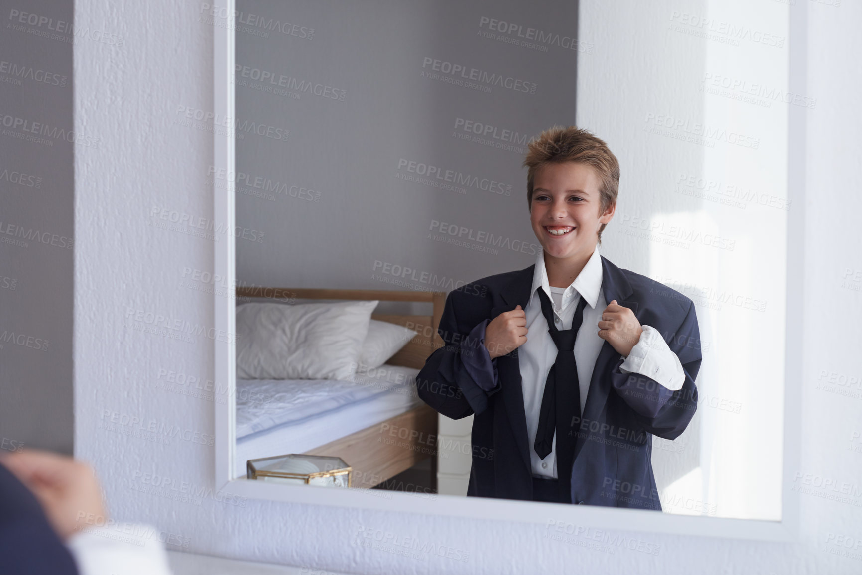 Buy stock photo Happy, boy and pretend suit on male person, business wear for dream job or dress up on kid. Smile, clothes for career aspirations day in school, costume and standing in bedroom mirror in home
