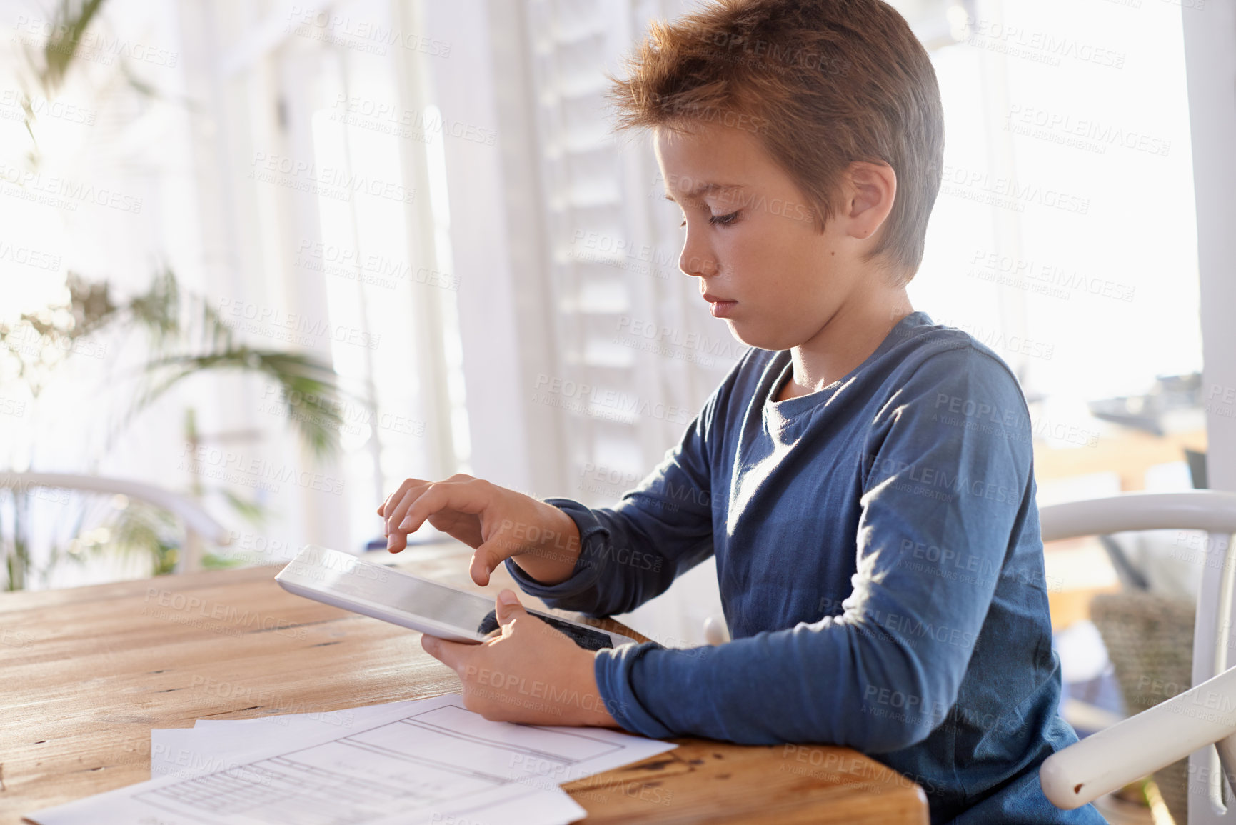 Buy stock photo Home, boy and paper with tablet for education on online learning for revision, study and child development. Homework, internet and research with information for assignment and school project.