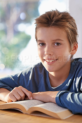 Buy stock photo Child, portrait and reading book for home relax on weekend for hobby activity in apartment, learning or story. Male person, boy and face or textbook resting for holiday vacation, peace or carefree