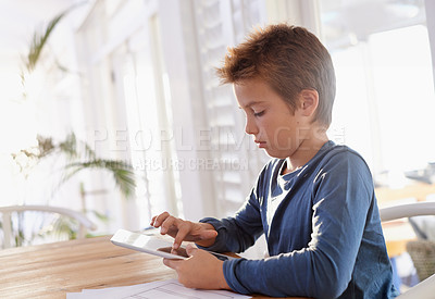 Buy stock photo Child, tablet and notes in house for homework, elearning and games on table with internet and online. Young boy or kid  with technology and finger on screen for touch, scroll or study for education 