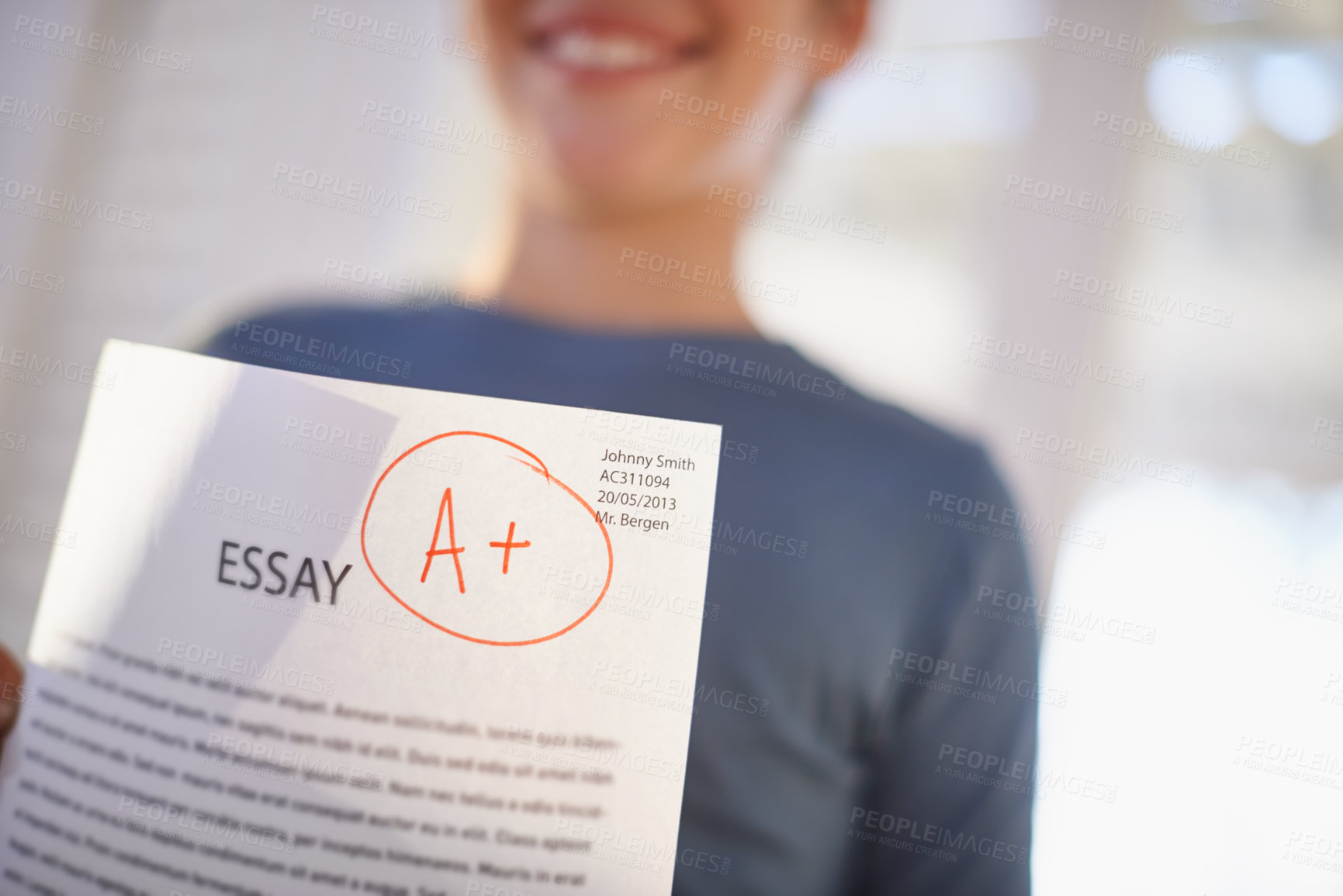 Buy stock photo Shot of a proud young boy holding up his essay that got him an A+