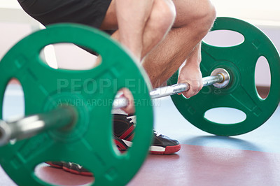 Buy stock photo Cropped shot of a man working out with weights in the gym