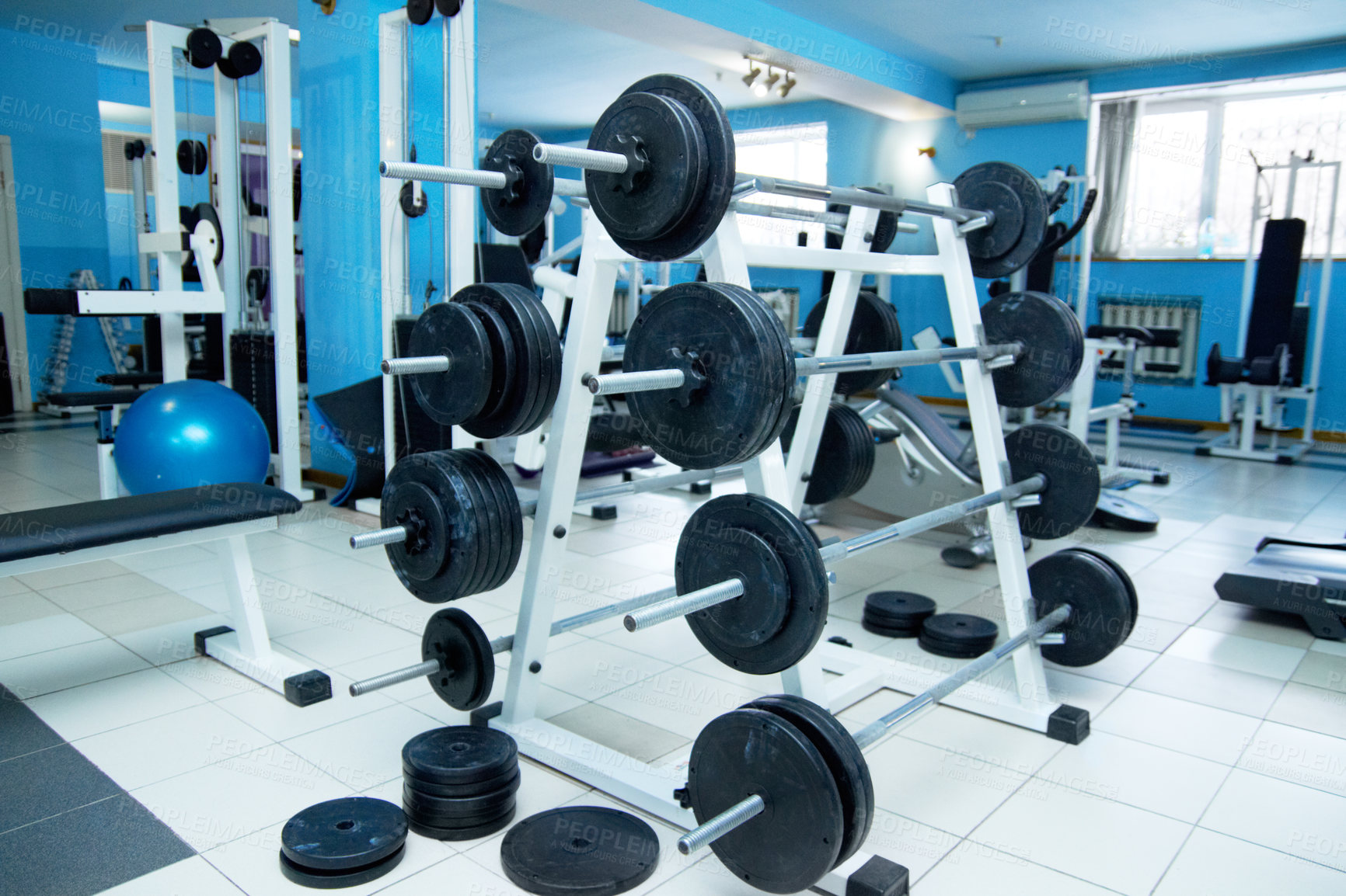 Buy stock photo Barbell rack, gym interior and fitness with equipment for wellness, healthy bodybuilding or training. Exercise, workout or health club with metal weights on shelf, strong body development and sports