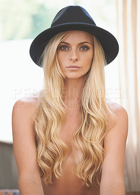 Buy stock photo Shot of a gorgeous young topless woman posing in a hat at home