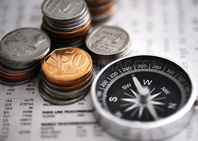 Buy stock photo Studio shot of coins and a compass on some documents