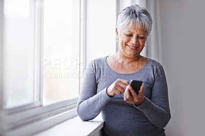 Buy stock photo Window, app and senior woman with a smartphone, connection and typing for social media at home. Mature lady, female person and model with a cellphone, communication and online reading with texting